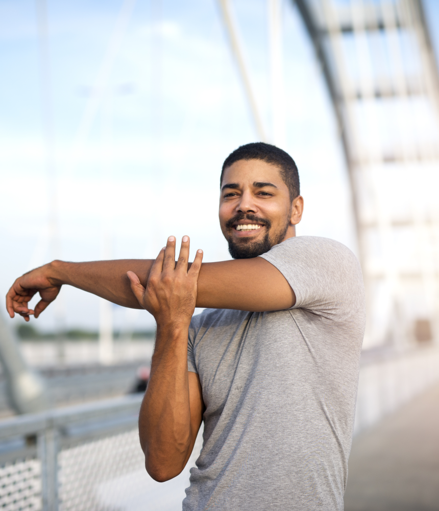 A man stretching his left shoulder